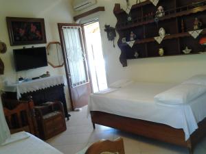 a bedroom with a bed and a fireplace and a television at Garden of Edem in Afissos
