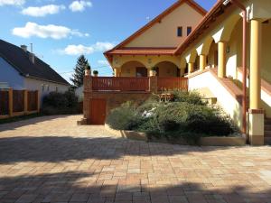 a house with a brick driveway in front of it at Vitis Vendégház in Becsehely