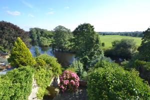 an aerial view of a garden with flowers and a river at Riverside Cottage in Wetherby