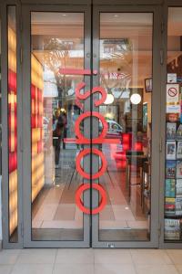 a store front with a red sign on the door at Oops! Latin quarter by Hiphophostels in Paris