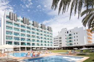 a hotel with a swimming pool in front of a building at Hotel Luxor in Playa de Palma