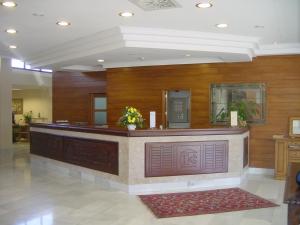 a lobby with a reception desk in a building at Hotel Cristina in Noreña