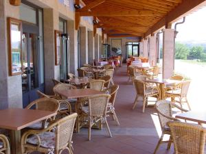 an empty restaurant with tables and chairs on a patio at Hotel Cristina in Noreña