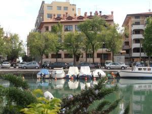 a group of boats in the water in a city at Villa Olimpia in Grado