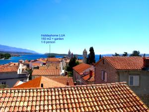 a view of a town with red roofs and the water at Holiday Home Lija Center in Rab