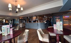 a restaurant with two tables and a bar at Spread Eagle, Gailey by Marston's Inns in Gailey