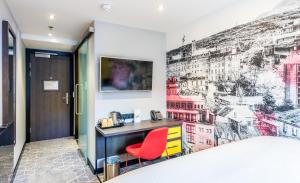 a bedroom with a wall mural of a city at KM Hotel in Edinburgh