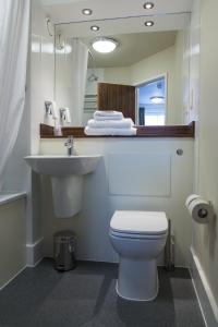 a bathroom with a white toilet and a sink at Spread Eagle, Gailey by Marston's Inns in Gailey