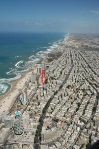 an aerial view of a city with a red arrow at Apartment On Mapu Street in Tel Aviv