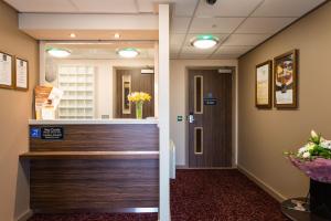 a lobby of a hospital with a wooden door at Sessile Oak, Llanelli by Marston's Inns in Llanelli