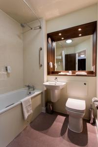 a bathroom with a sink and a toilet and a bath tub at Sessile Oak, Llanelli by Marston's Inns in Llanelli