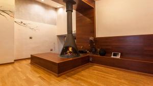 a kitchen with a fireplace in the middle of a room at Hanso Presidential Suite Hanok Hotel in Seoul
