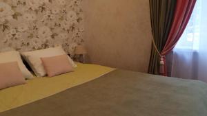 a bedroom with a bed with two pillows at Apartment on Brivzemnieka in Liepāja