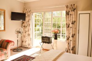a bedroom with a tv and a window at Gate 66 in Somerset East
