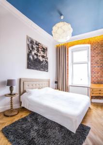 a bedroom with a large white bed and a window at Old Town - Green Apple in Wrocław