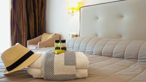 a hotel room with a bed with a hat and glasses at Lagomandra Hotel and Spa in Lagomandra