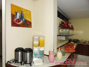 a kitchen with a counter with a counter top with a counter top at Hotel Moura in Brumado