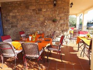 a dining room table with chairs and umbrellas at Agriturismo Villa Russo in Caltanissetta