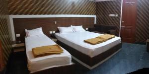 A bed or beds in a room at Sapphire Inn