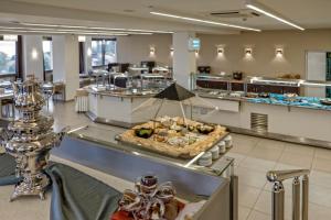 a restaurant with a buffet of food on a counter at Lagomandra Hotel and Spa in Lagomandra