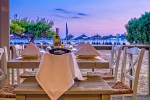 a table with a bottle of wine on top of it at Lagomandra Hotel and Spa in Lagomandra