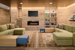 a living room with couches and a fireplace at Country Inn & Suites by Radisson, Novi, MI in Novi