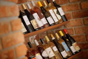 a bunch of wine bottles hanging on a brick wall at Park Central Hotel in Bournemouth