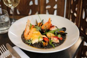a plate of food with shrimp on a table at Park Central Hotel in Bournemouth