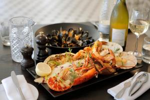 a plate of food with shrimp and mussels on a table at Park Central Hotel in Bournemouth