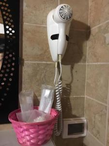 a hair dryer on a wall next to a basket at B&B Le Stagioni in Castel del Monte