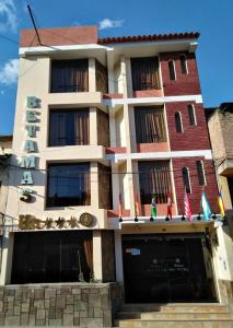 a building with flags on the front of it at Retamas Hotel in Cajamarca