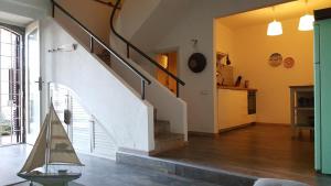 a living room with a staircase in a house at La Barca di Pozzillo in Acireale