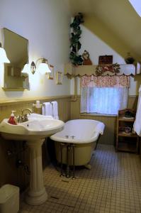 a bathroom with a tub and a sink at The Oliver Inn in South Bend