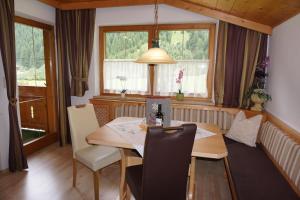 a dining room with a table and chairs at Haus Troger in Milders