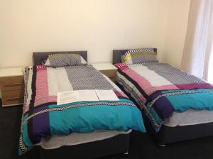 2 Betten nebeneinander in einem Zimmer in der Unterkunft Manor Studio in Walsall