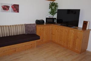 a room with a couch and a flat screen tv at Haus Troger in Milders