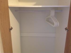 a closet with a door with a hanger in it at Manor Studio in Walsall