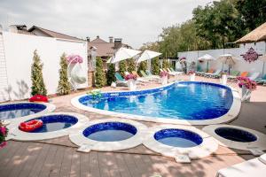 a swimming pool with blue water in a backyard at Hotel Complex Dacha in Vinnytsya