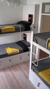 a room with three bunk beds in it at Albergue Gran Canaria in Las Palmas de Gran Canaria