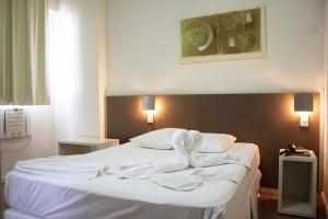 Cama ou camas em um quarto em Excellence Comfort Hotel