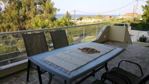 a blue table and chairs on a balcony at Villa Bianca in Káto Pitsá