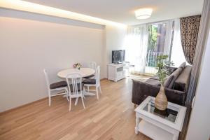 a living room with a table and a couch at IN24 in Palanga