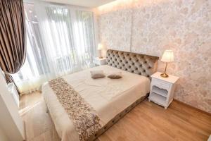 a bedroom with a large bed and a window at IN24 in Palanga