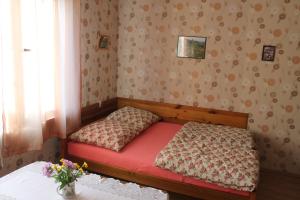 シュツァブニツァにあるMichalowka w Szczawnicyの赤いベッドと窓付きの小さなベッドルーム1室が備わります。