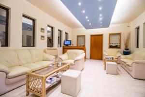 a large living room with couches and a table at Stavros Melathron Studios in Kallithea Rhodes