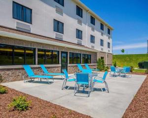 a group of chairs and tables in front of a building at Comfort Inn in Ferdinand