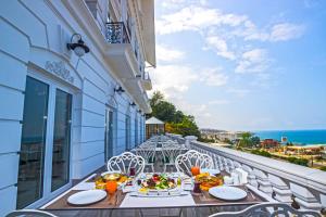 a balcony with a table and chairs and the ocean at Mell Hotel in Trabzon