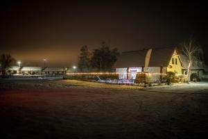a barn at night with lights in a field at Penzion Podyjí in Znojmo +1 photo