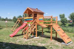 a playground with a slide and a play house at Penzion Podyjí in Znojmo