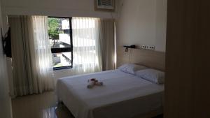 Ένα ή περισσότερα κρεβάτια σε δωμάτιο στο Apart Hotel em Ondina +25 φωτογραφίες